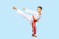 Beautiful kick foot performed by a boy with orange belt