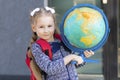 Beautiful kid back to school. Smart schoolchild with red schoolbag holding globe in hands. Education Royalty Free Stock Photo