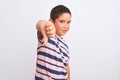 Beautiful kid boy wearing casual striped t-shirt standing over isolated white background looking unhappy and angry showing Royalty Free Stock Photo