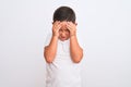 Beautiful kid boy wearing casual t-shirt standing over isolated white background with hand on head for pain in head because stress Royalty Free Stock Photo