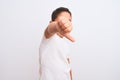 Beautiful kid boy wearing casual t-shirt standing over isolated white background looking unhappy and angry showing rejection and Royalty Free Stock Photo