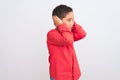 Beautiful kid boy wearing elegant red shirt standing over isolated white background with hand on head for pain in head because Royalty Free Stock Photo