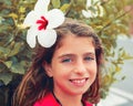 Beautiful kid girl with hibiscus flower in hair