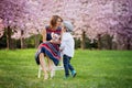 Beautiful kid and mom in spring park, flower and present. Mother Royalty Free Stock Photo