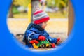 Child playing excavator on the street