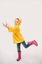 beautiful kid in rubber boots and yellow raincoat