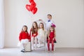 Beautiful kids friends with red balloons in the shape of a heart at the holiday Royalty Free Stock Photo