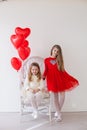 Beautiful kids friends with red balloons in the shape of a heart at the holiday Royalty Free Stock Photo