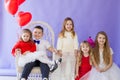 Beautiful kids friends with red balloons in the shape of a heart at the holiday Royalty Free Stock Photo