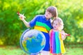 Beautiful kids playing with airplanes and globe Royalty Free Stock Photo