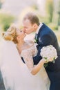 Beautiful kissing wedding couple in spring nature close-up portrait Royalty Free Stock Photo