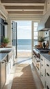 Beautiful kitchen in Cape Cod home features stunning ocean views through open doors. Natural light floods space, highlighting Royalty Free Stock Photo