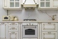 A beautiful kitchen detail with white cabinets, a gold faucet, white marble countertops Royalty Free Stock Photo