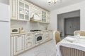 A beautiful kitchen detail with white cabinets, a gold faucet, white marble countertops Royalty Free Stock Photo