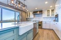 Beautiful kitchen room with green island and farm sink.