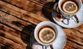 Beautiful kitchen set for a tea ceremony for two people. Two white ceramic tea cups on saucers on a wooden table. Black tea with Royalty Free Stock Photo