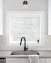 A kitchen sink detail in a white, cozy kitchen. Royalty Free Stock Photo