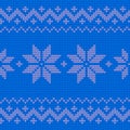 Beautiful knitted blue jacquard seamless pattern with flowers.