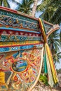 Beautiful Kolae boat, traditional Thai-Malayu fishing boat. Colorful mural painting and color cloth hanging on the bow of the boat