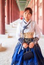 Beautiful Korean woman dressed Hanbok in Gyeongbokgung Palace in Seoul Royalty Free Stock Photo