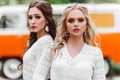 Beautiful ladies standing near retro car.