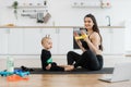 Baby learning exercises with stretch band from mom at home