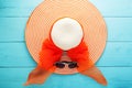 Beautiful lady beach hat with sunglasses on blue wooden background,summer holiday background concept. Royalty Free Stock Photo