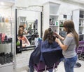 Beautiful lady doing hair in the salon.Hairdresser doing haircut in hairdressing salon. Russia. Saint-Petersburg. The summer of 2