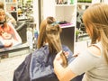 Beautiful lady doing hair in the salon.Hairdresser doing haircut in hairdressing salon. Russia. Saint-Petersburg. The summer of 2