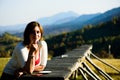 Beautiful lady drinking coffee. Mountain view