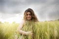 beautiful lady embracing ears of wheat outdoor