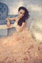 Beautiful lady in gorgeous couture dress on sofa Royalty Free Stock Photo