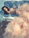 Beautiful lady in gorgeous couture dress on sofa Royalty Free Stock Photo