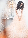 Beautiful lady in gorgeous couture dress in white interior Royalty Free Stock Photo