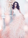 Beautiful lady in gorgeous couture dress in white interior Royalty Free Stock Photo