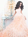 Beautiful lady in gorgeous couture dress in white interior Royalty Free Stock Photo