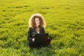 Beautiful lady with her laptop on grass Royalty Free Stock Photo