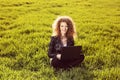 Beautiful lady with her laptop on grass Royalty Free Stock Photo