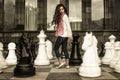 Beautiful lady near chess desk
