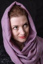 Beautiful lady in neckerchief studio portrait on black background.