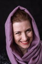 Beautiful lady in neckerchief studio portrait on black background.