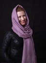 Beautiful lady in neckerchief studio portrait on black background.