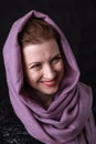 Beautiful lady in neckerchief studio portrait on black background.