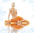 Beautiful lady with orange towels on white sand Royalty Free Stock Photo