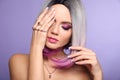 Beautiful lady presents amethyst ring and bracelet jewelry set. Woman portrait with ombre bob short hairstyle and manicured nails