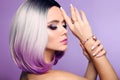 Beautiful lady presents amethyst ring and bracelet jewelry set. Woman portrait with ombre bob short hairstyle and manicured nails