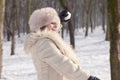 Beautiful lady pulls snowballs in the woods Royalty Free Stock Photo