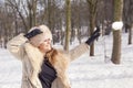 Beautiful lady pulls snowballs in the woods Royalty Free Stock Photo