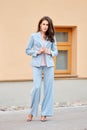 Beautiful lady in skyblue pantsuit on the street