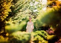 Beautiful lady in sunlight garden Royalty Free Stock Photo